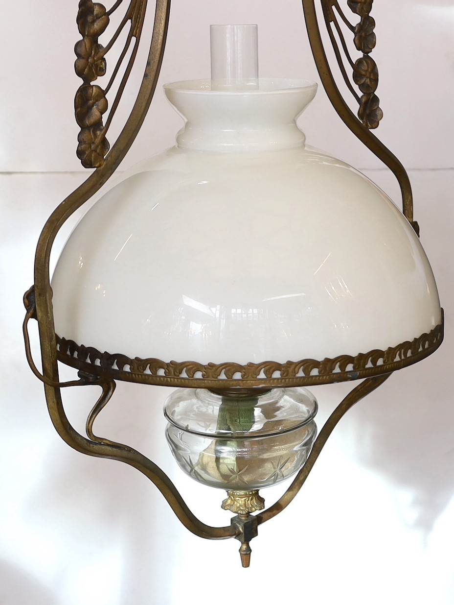 A late 19th century French bronze and cut glass hanging oil lamp with opaque glass shade, drop 90cm.